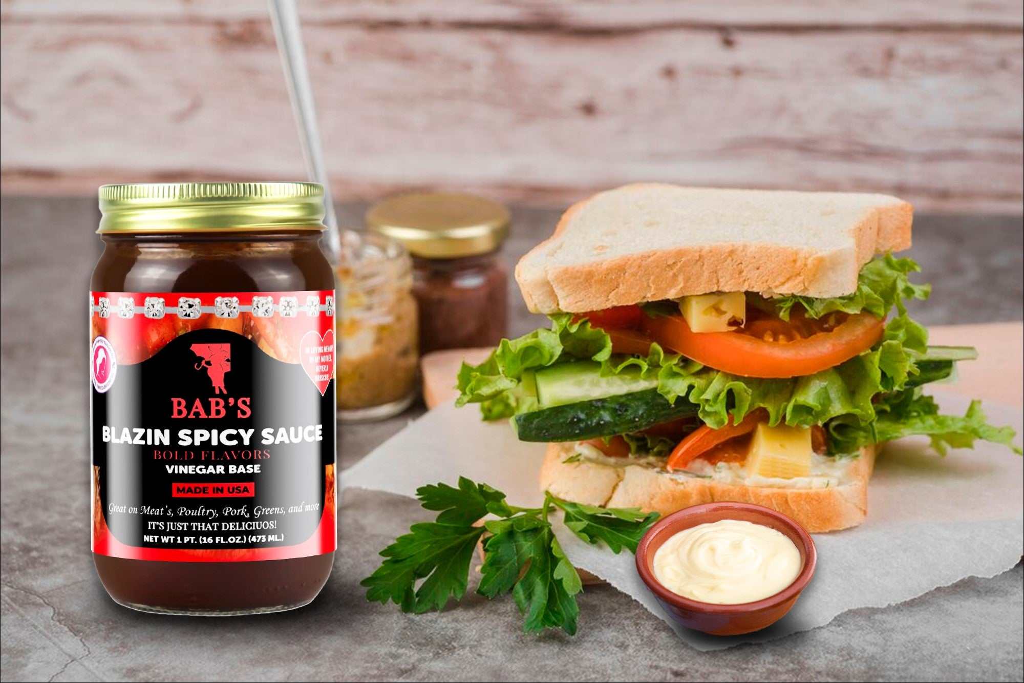 Blazin Spicy Sauce jar next to a sandwich and sauce dip on a table.